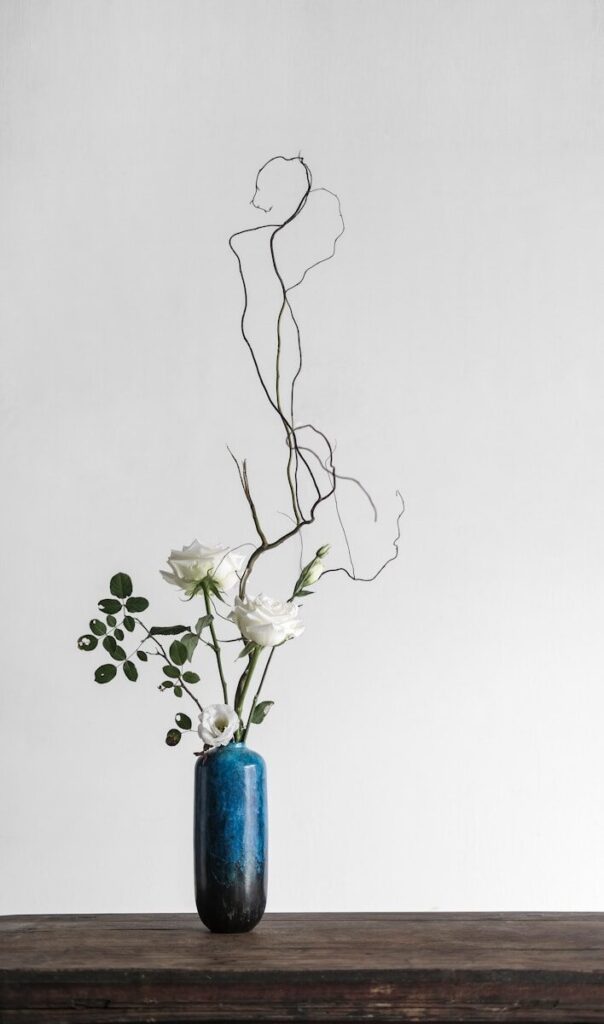 white flowers in blue vase