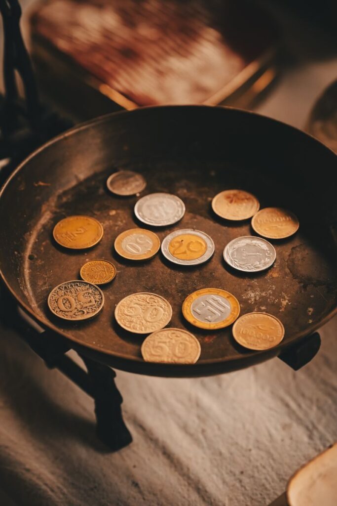 A collection of Turkish coins displayed on a vintage scale, showcasing currency diversity.